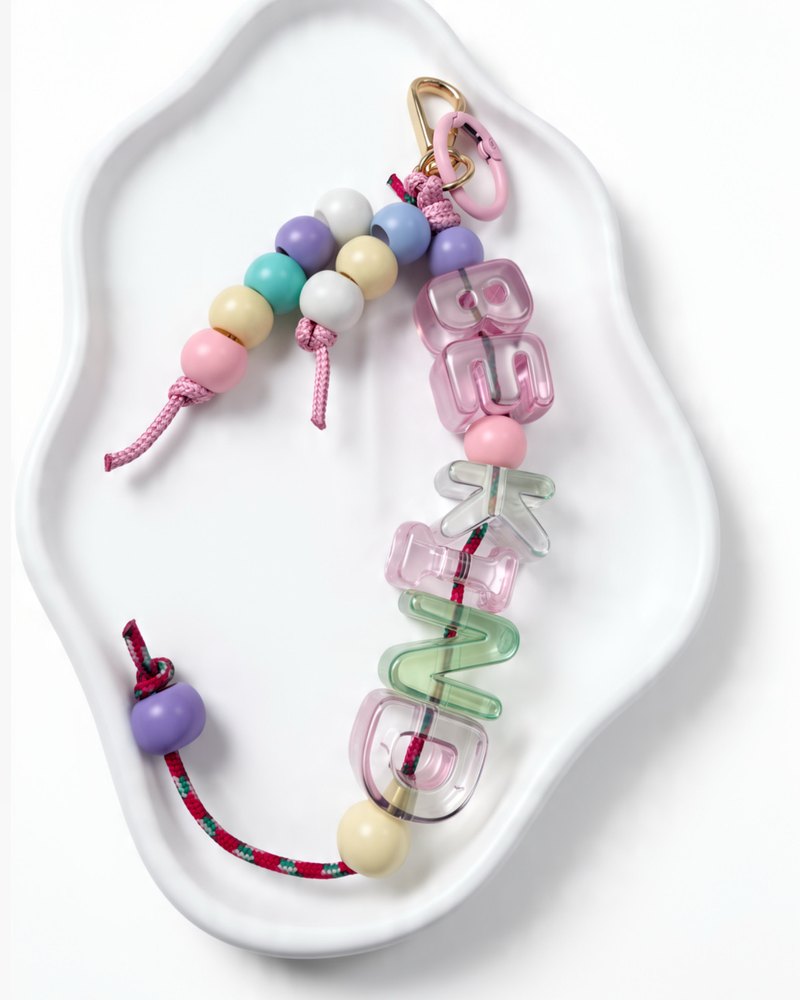 BE KIND keychain with clear pink letters and pastel beads