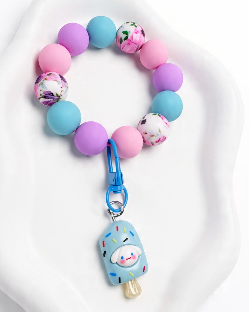 Lilac, pink and blue floral silicone wristlet with a blue ice pop charm