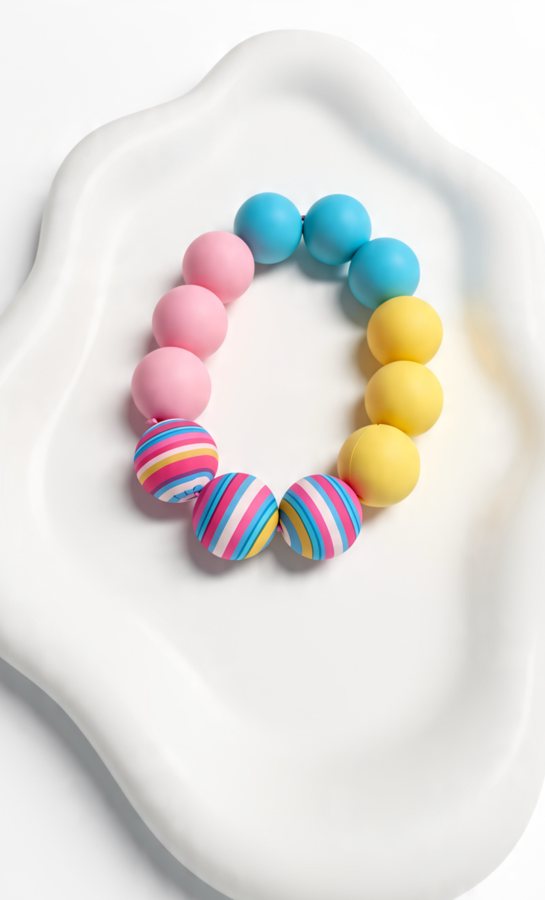 Pink, blue and yellow silicone bracelet with three striped beads