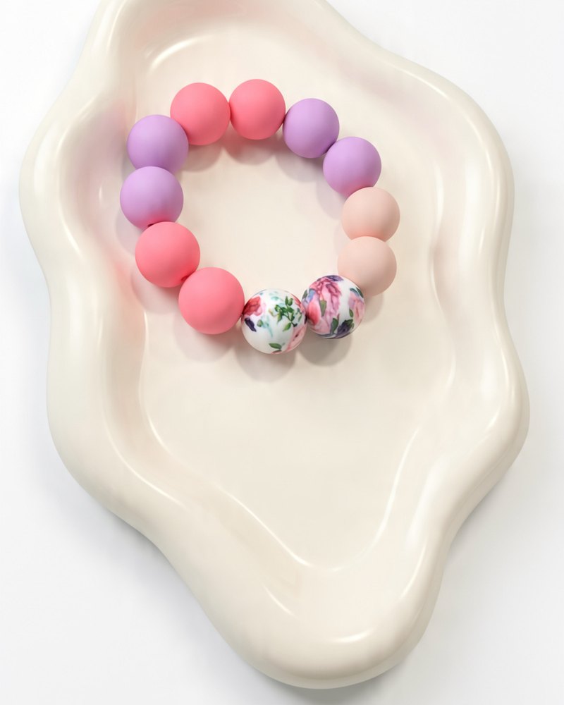 Pink and lavender silicone bracelet with two floral beads
