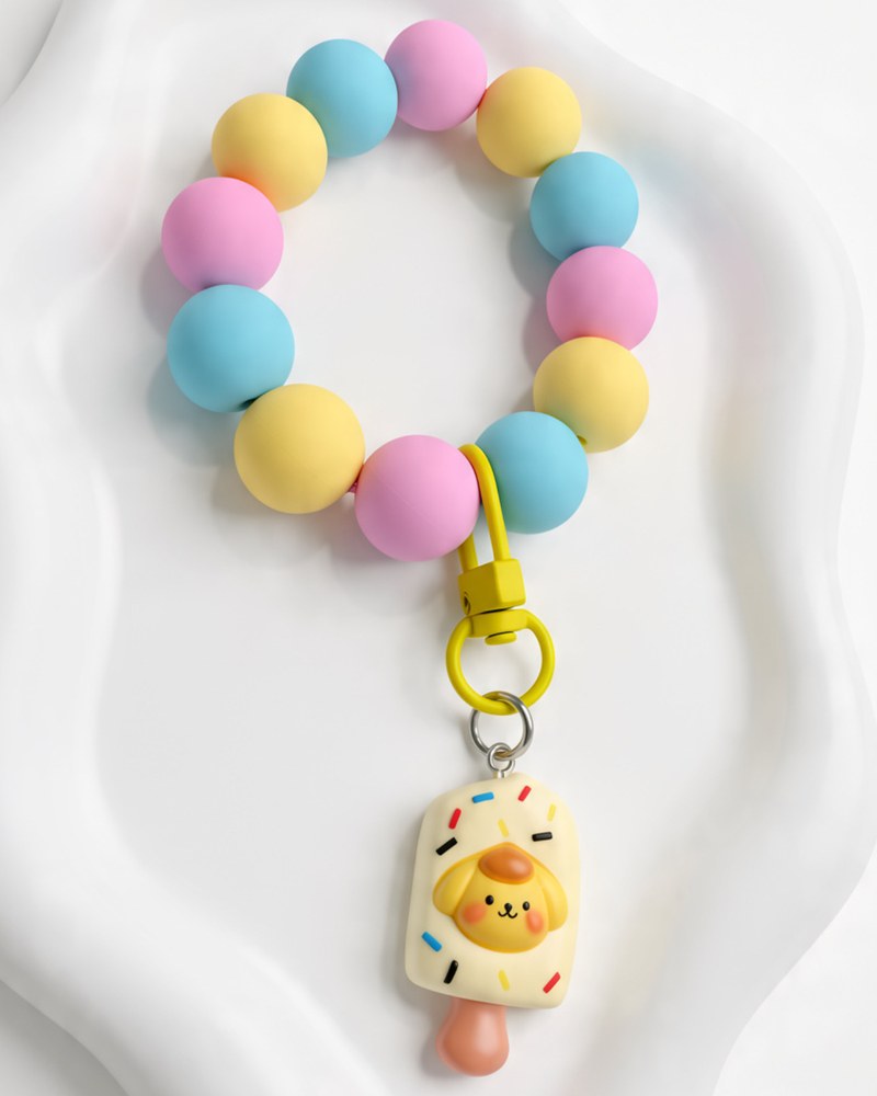 Pastel pink, blue and yellow silicone wristlet with a cream ice pop charm