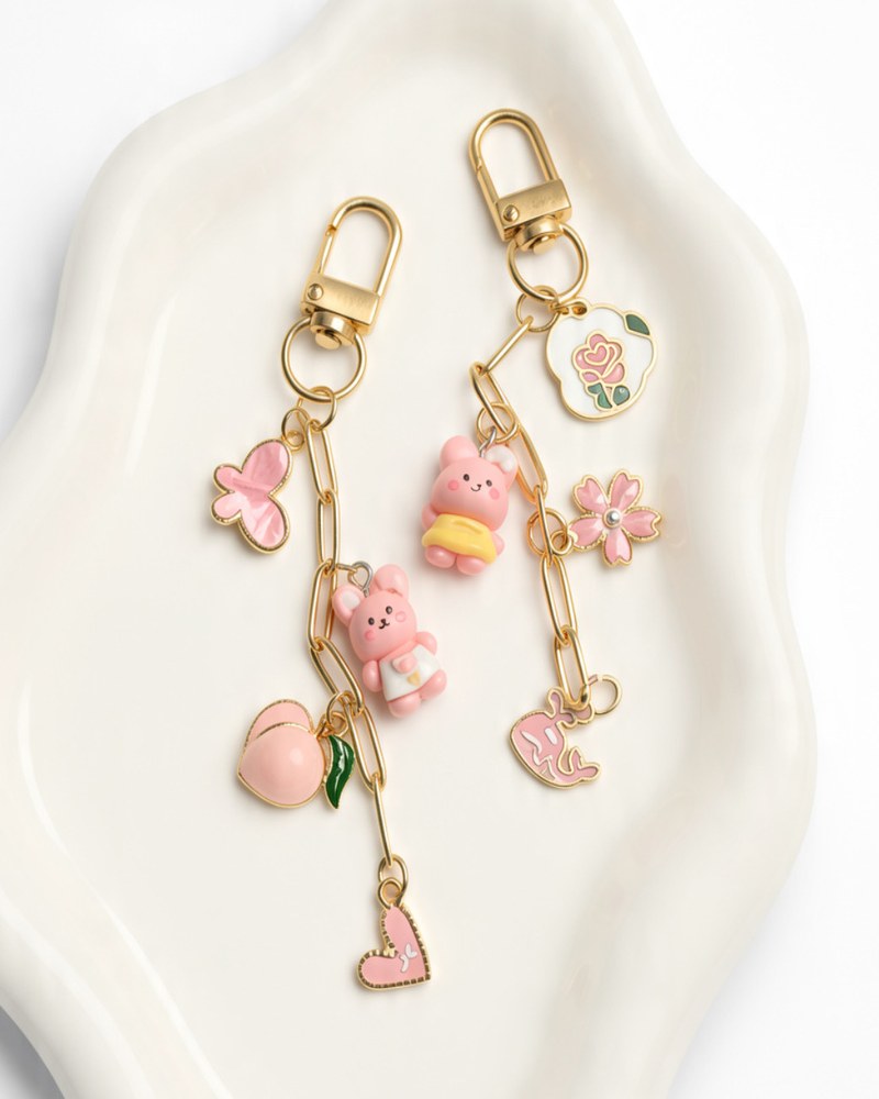 Two gold chain charm clips with pink butterfly, bunny, peach, heart, rose and flower charms