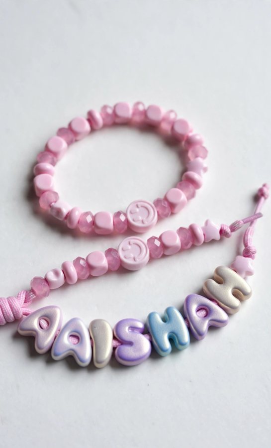 Pink name bracelet spelling AAISHAH with a matching pink bead bracelet