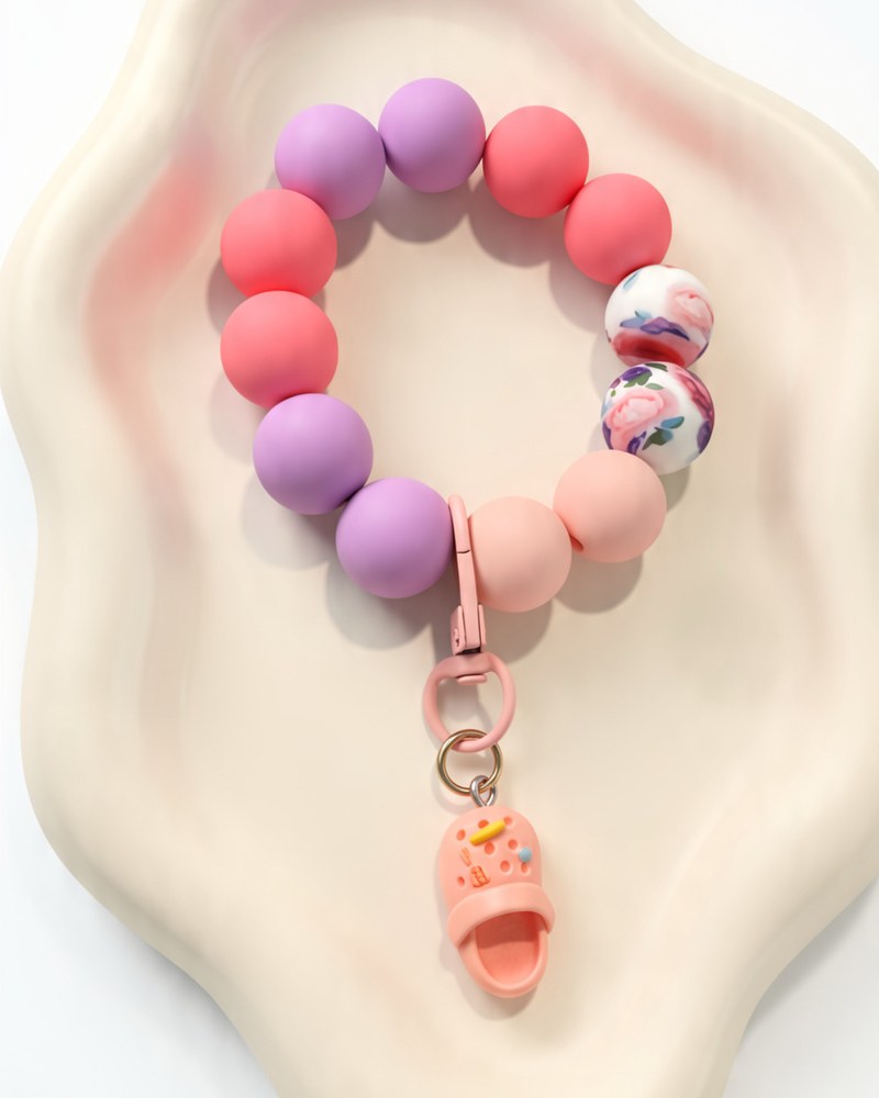 Coral, lilac and floral silicone wristlet with a mini peach clog charm