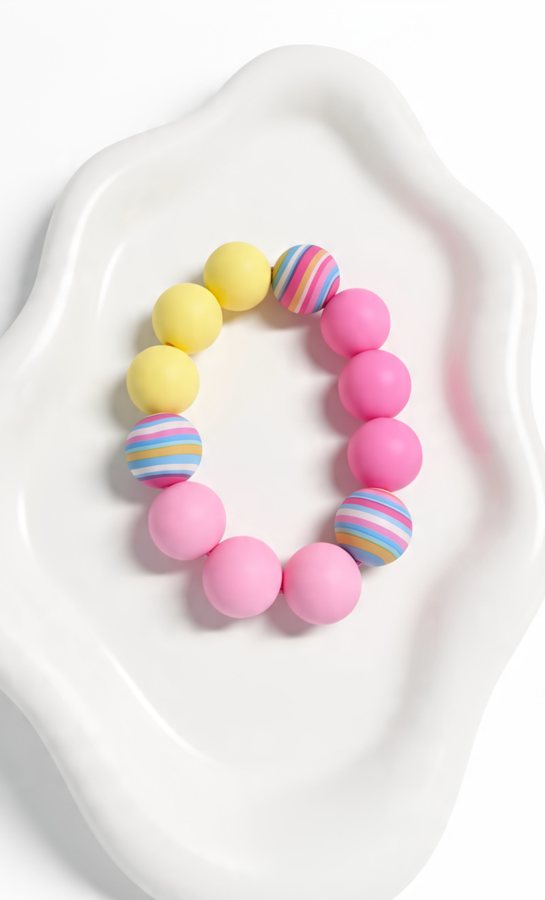 Pink and yellow silicone bracelet with rainbow striped beads