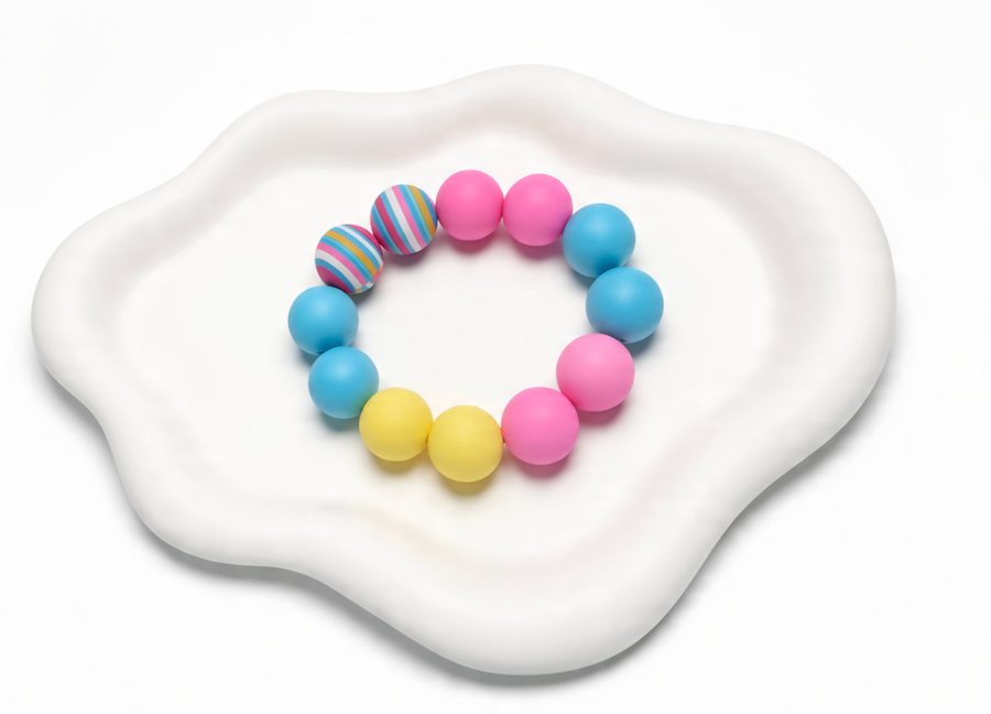 Pink, blue and yellow silicone bracelet with striped beads