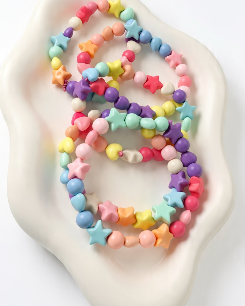 Three pastel star-bead bracelets stacked