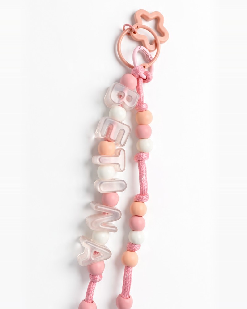 Blush pink double-string paracord keychain with pastel letters, pink and peach beads and a star ring
